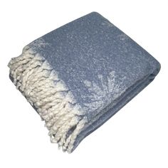 a blue and white throw with fringes on it's edges is folded up