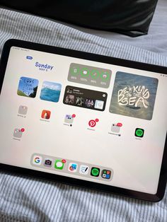 an ipad sitting on top of a bed