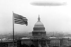 an alien flying over the capitol building in black and white