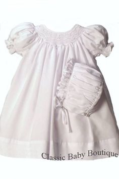 Adorable Petit Ami all white batiste daygown. Sweet wave bishop smocking with tiny hand embroidered white rosettes. Smocking has a lined panel inside to protect baby's delicate skin. Smocking continues on to the back of the gown with button back for easy dressing. Even the sleeve cuffs have smocking! Lovely white coordinating bonnet with matching smocking completes this darling set. Lovely for Christening, Baptism or Dedication as well. 2 pieces include the dress & bonnet. Size Preemie (prematur Smocked Bishop Dress, Smocked Baby Dresses, Infant Clothes, Preemies, Smocked Dresses, Christening Dress, Kids Frocks, Heirloom Sewing, Baby Christening