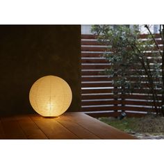 a round light sitting on top of a wooden table