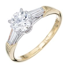 Diamond engagement ring. Platinum and 18k yellow gold three-stone setting with a GIA certified round center diamond and two tapered baguette side diamonds. Ideal cut diamond, approx. total weight .90cts, and 6.18 x 6.24 x 3.85 mm, F, VVS1, Depth: 62% Table: 56%. GIA certificate#1152065118 2 tapered baguette diamonds, approx. total weight .34cts, F, VVS Size 7 and sizable 18k Yellow Gold Platinum Stamped: Pt 900 18k AEB 4.1 grams Width at top: 6.2mm Height at top: 6.4mm Width at bottom: 2mm Engagement Ring Platinum, Diamond Baguette, Stone Gold, Platinum Ring, Three Stone Rings, Baguette Diamond, Ring Vintage, Gold Platinum, Vintage Engagement Rings