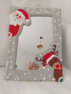 a christmas themed mirror with santa clause on it