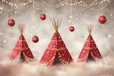 three teepees with christmas decorations hanging from them