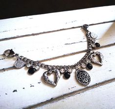 The single-row Charivari made of stainless steel is a beautiful accessory that refines any dirndl or traditional outfit. A small, decorated amulet, winged hearts, coins, rhinestones and enamel pendants were attached to a solid stainless steel chain, creating a special eye-catcher. With a length of approx. 18.50 cm, the Charivari can easily be attached to aprons and bodices thanks to the large, sturdy carabiner. Each Charivari is delivered safely packaged in a gift box, making it ideal as a gift. Enamel Pendants, Jewelry Traditional, Traditional Outfit, Box Making, Steel Chain, Stainless Steel Chain, Traditional Outfits, The Row, Charm Necklace