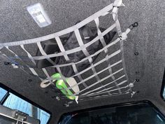 the interior of a vehicle with an overhead hammock attached to the back of it