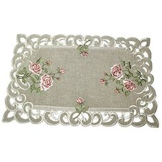 an embroidered placemat with pink roses on the edge and white border, in front of a white background