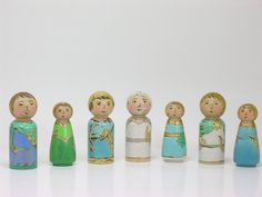 a group of wooden dolls standing next to each other