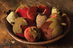 a bowl filled with lots of different types of fruit on top of a wooden table