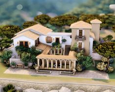 a model of a house with trees and bushes around it