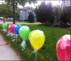 some balloons are lined up on the grass