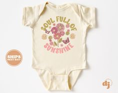 "Baby Onesie® - Soul Full of Sunshine Flower Bodysuit - Wild Flower Retro Natural Onesie® All of the shirts and bodysuits at our shop are CPSIA compliant. We only use Eco-friendly, water-based inks that are also CPSIA compliant and boasts strong washability (highest score on AATCC wash test).  So rest assure to put them on your little ones!  ** COLOR OF T-SHIRTS WILL VARY SLIGHTLY DUE TO LIGHTING AND/OR MONITOR SETTINGS ** DETAILS OF BABY BODYSUITS & T-SHIRTS MAY VARY SLIGHTLY FROM PRODUCT PHOTOS BASED ON AVAILABLE INVENTORY HOW TO ORDER: Please follow these 5 simple steps: 1. Select the style and size you want in the \"Style (Size)\" option.  2. Select the shirt color you want in the \"Color\" option. 3. [APPLICABLE ONLY ON CERTAIN LISTINGS] Follow the instructions to fill out the \"Add y Fitted Floral Print Onesie For Summer, Yellow Short Sleeve Bodysuit For Spring, Spring Yellow Short Sleeve Bodysuit, Yellow Short Sleeve Onesie For Spring, Spring Yellow Short Sleeve Onesie, Spring White Graphic Print Bodysuit, Fitted White Onesie With Floral Print, Flower Bodysuit, Soul Full Of Sunshine