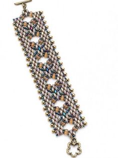 a beaded bracelet with charms and beads on the clasp, hanging from a chain