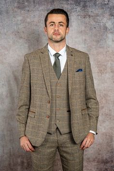 As worn by West Ham United goalkeeper Lukasz Fabianski! This Ted suit offers a sophisticated take on English gent-style, crafted with a traditional herringbone wool-mix cloth in earth-toned hues. The multi-tonal check pattern invokes 19th century tweed yet the contemporary colour accents make it ideal for any 21st century wardrobe. Matching children's suit available. Features Herringbone Slim fit Single-breasted Notch lapel Single back vent Four button cuff Double button blazer fastening Complim Brown Tweed Suit With Herringbone Pattern, Brown Tweed Jacket With Suit Collar, Timeless Tweed Jacket With Welt Pockets, Tailored Brown Tweed Jacket, Herringbone Tweed Jacket For Business, Tailored Brown Tweed Suits, Tailored Classic Wool Tweed Dress, Timeless Tweed Suits For Fall, Tailored Herringbone Tweed Jacket In Timeless Style