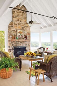 a living room filled with lots of furniture and a fire place in the middle of it