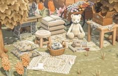 a teddy bear sitting on top of a rug next to pillows and other items in a room