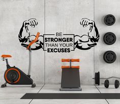 an exercise room with a wall decal that says be stronger than your exercises