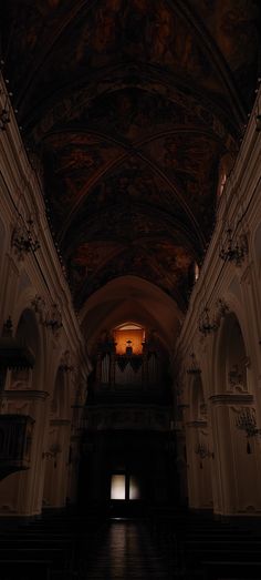 an empty church with pews and stained glass windows