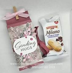 two bags of candy and some candies on a white surface with a pink ribbon