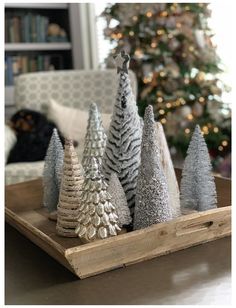 small christmas trees sitting on top of a wooden tray