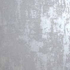 a white and gray wall that has been painted with some paint chippings on it