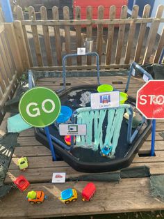 a toy train set sitting on top of a wooden table next to a stop sign