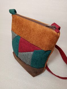 "This colourful crossbody/shoulder bag is made from soft faux leather and water resistant faux wool fabric.  This handmade bag is 100% vegan and totally unique. It has a zip closure, an adjustable strap and a zipped inner pocket.   Approximate measurements: width at base 20 cm (8\"), width at opening 24 cm (9.5\"), height 23 cm (9\"), depth 8.5 cm (3.5\"), strap extends to 137 cm (54\")" Winter Shoulder Bag With Zipper For Everyday Use, Everyday Winter Shoulder Bag With Zipper, Multicolor Fall Shoulder Bag For Everyday Use, Fall Travel Bags With Zipper Pouch, Winter Everyday Bags With Zipper Pocket, Brown Crossbody Shoulder Bag For Winter, Casual Brown Shoulder Bag With Zipper Pouch, Multicolor Rectangular Bags For Winter, Brown Winter Crossbody Shoulder Bag