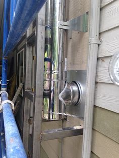 a metal pipe is attached to the side of a house