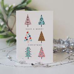 a christmas card with different trees on it