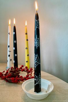 three candles sitting on top of a white plate