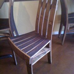 a wooden chair sitting in front of a mirror on top of a hard wood floor