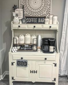 an old fashioned coffee bar is decorated with white and black accents, such as mugs