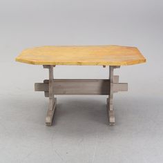 a wooden table sitting on top of a white floor