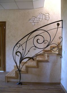 a spiral staircase with wrought iron handrails