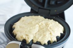 a waffle maker with some food inside of it