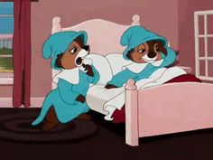 two children in blue outfits sitting on a bed