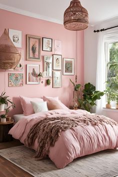 a bedroom with pink walls and pictures on the wall, including a bed in front of a window