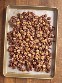 chocolate covered nut clusters on a baking sheet