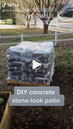 a pile of concrete sitting in the middle of a yard next to a wooden fence