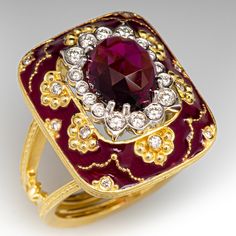 a ring with a large red stone surrounded by white and yellow diamonds