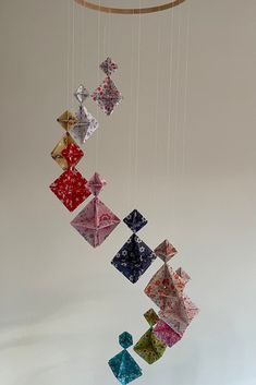 an origami mobile hanging from the ceiling