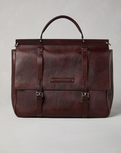 Calfskin casual briefcase The excellence of Brunello Cucinelli leathers defines the sophisticated and retro-inspired style of this calfskin Casual briefcase. The material’s natural grain and its uneven coloration make each piece unique. The large flap closure with adjustable buckles protects the accessory, which features small pockets and three expandable compartments, ideal for storing documents, a laptop, a tablet and all the essentials. Holdall Bag, Brown Accessories, Men's Totes, Latest Bags, Briefcase For Men, Eyewear Womens, Purple Leather, Purple Bags, Boutique Online