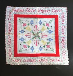 a white and red quilt with words on it