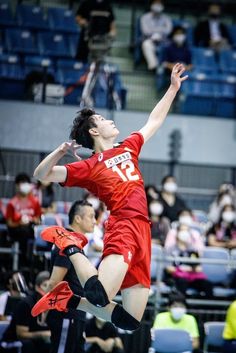 a man jumping up in the air to hit a ball