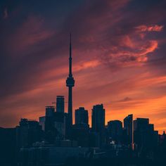 the sky is red and orange as the sun sets in toronto, canada on march 25, 2012