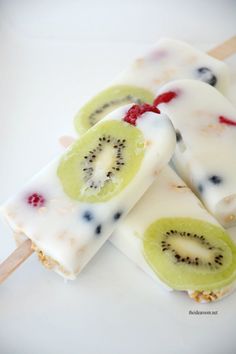 three popsicles with kiwi slices on them