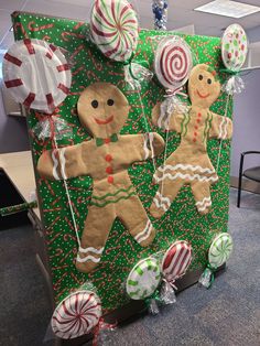 an office cubicle decorated for christmas with gingerbreads and lollipops