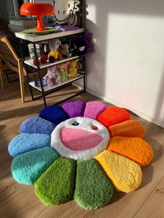 a multicolored rug on the floor in a child's room