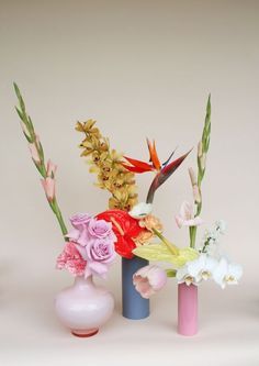 three vases filled with different types of flowers