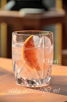 a glass filled with ice and an orange slice